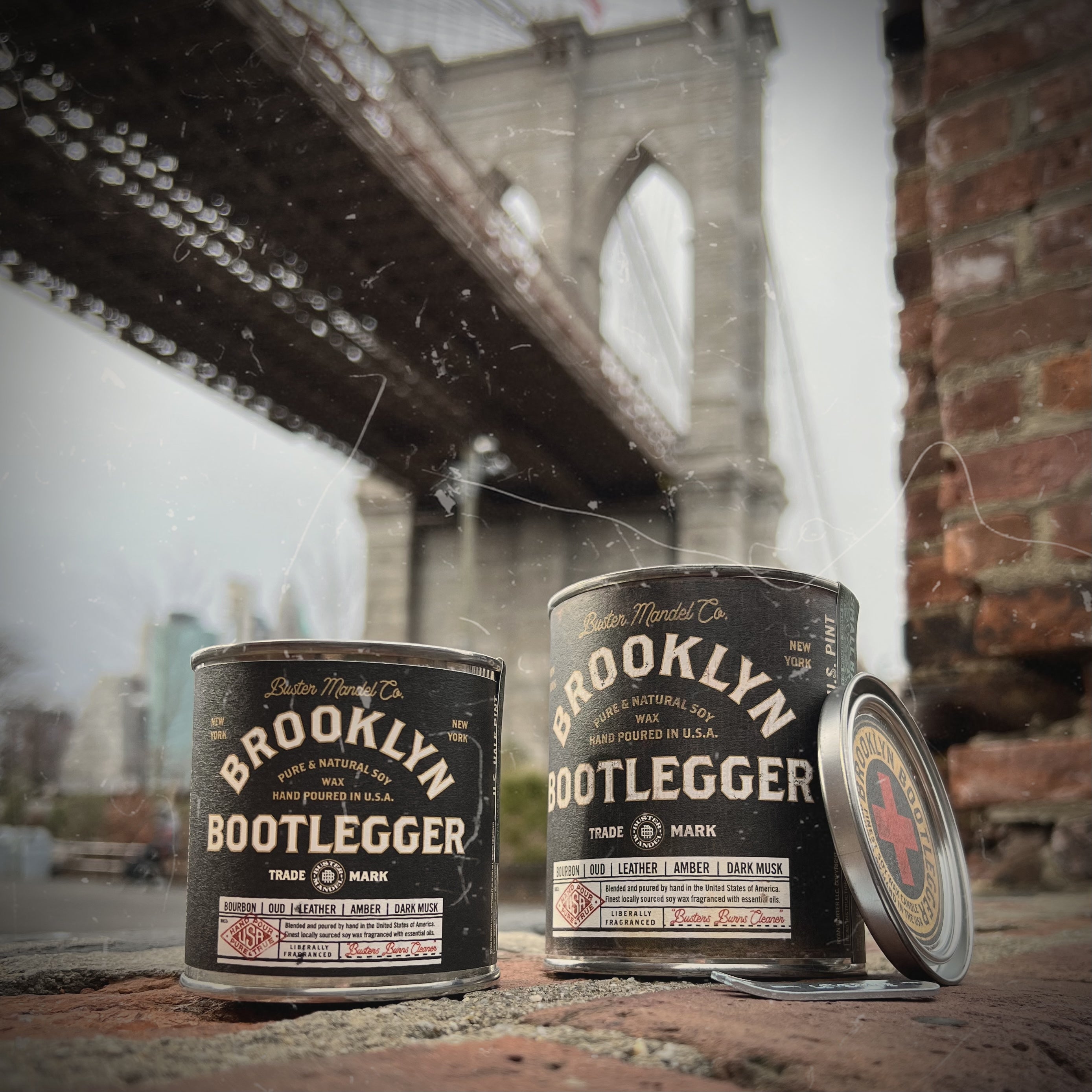 Buster Mandel Brooklyn Bootlegger Candles set against the iconic Brooklyn Bridge New York—luxury masculine soy candles with bourbon, leather, and smoke fragrance