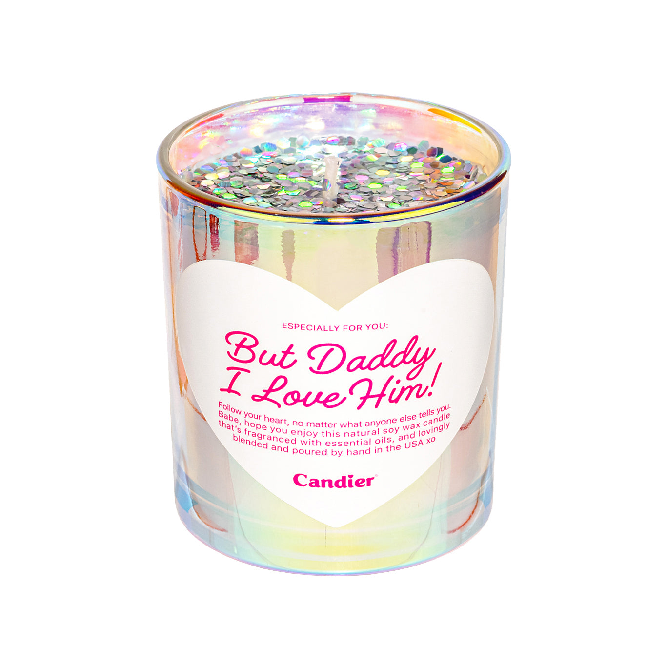 A shiny metallic scented candle with sparkling plant based glitter, and a heart shaped label that reads But Daddy, I Love Him by Candier®