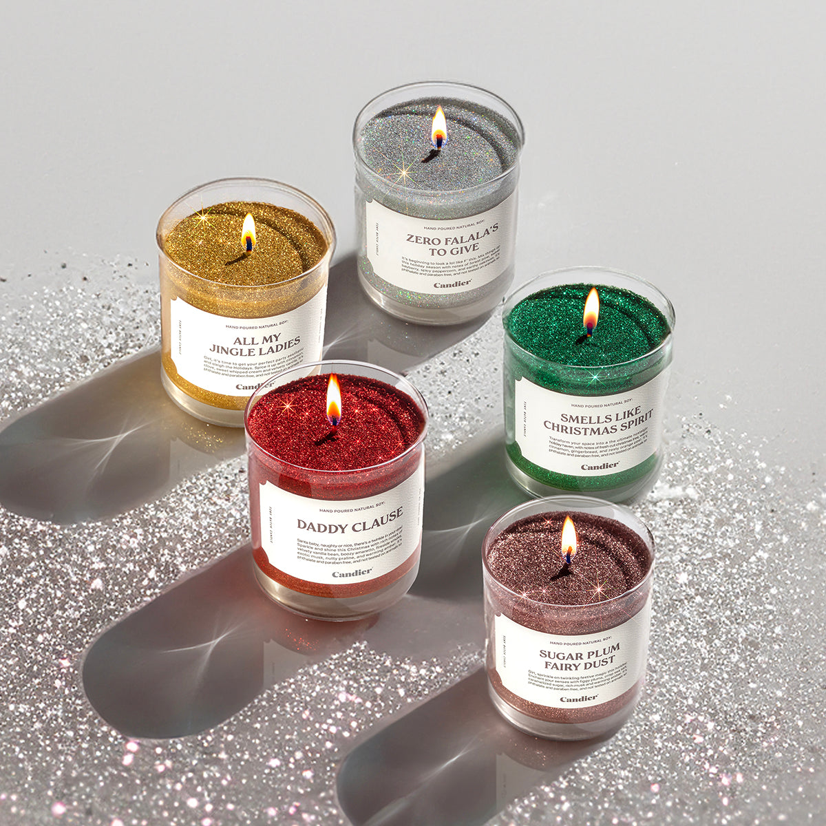 a collection of festive glitter candles with fun Christmas and holiday messages