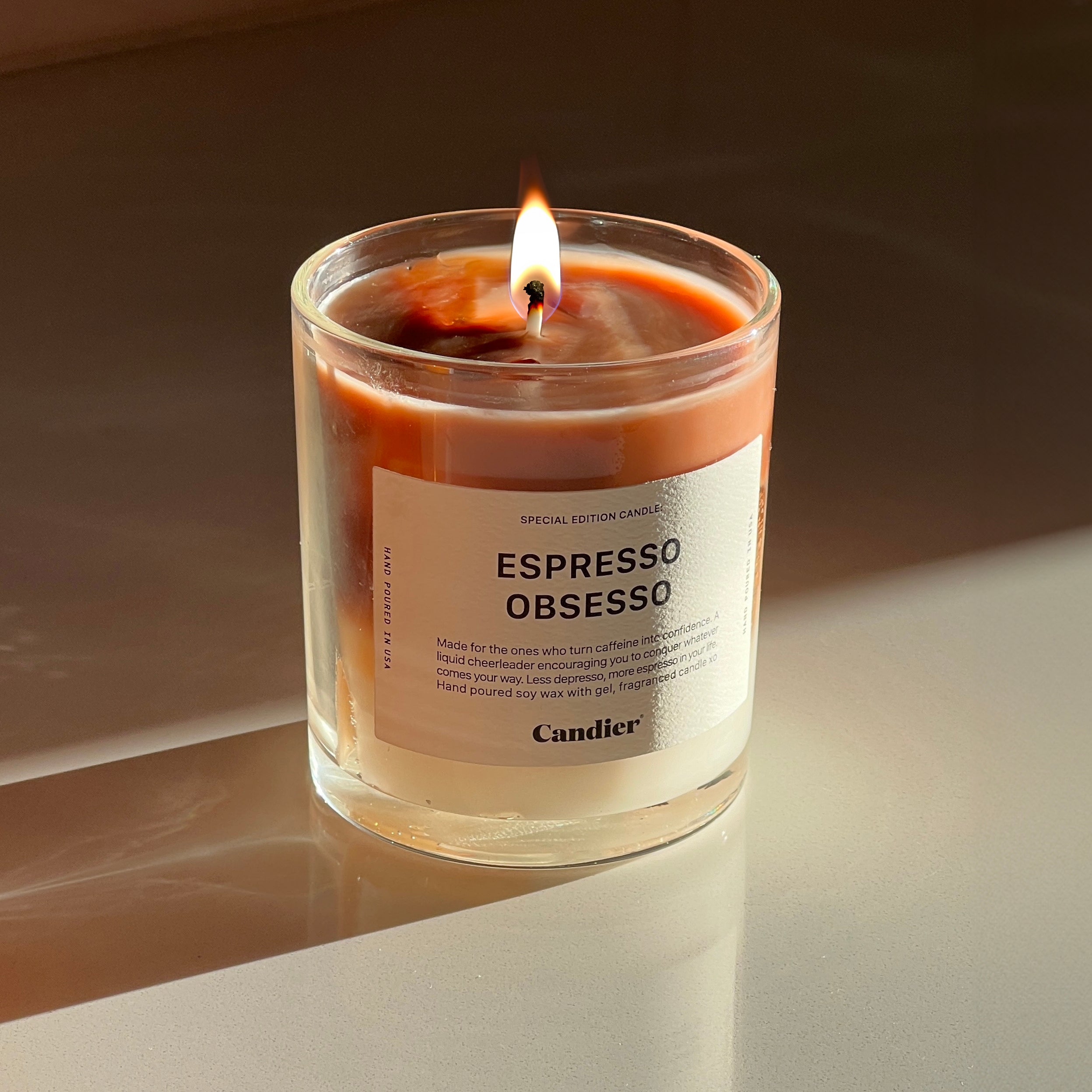 Ice coffee espresso latte inspired lit candle with a label that reads Espresso Obsesso