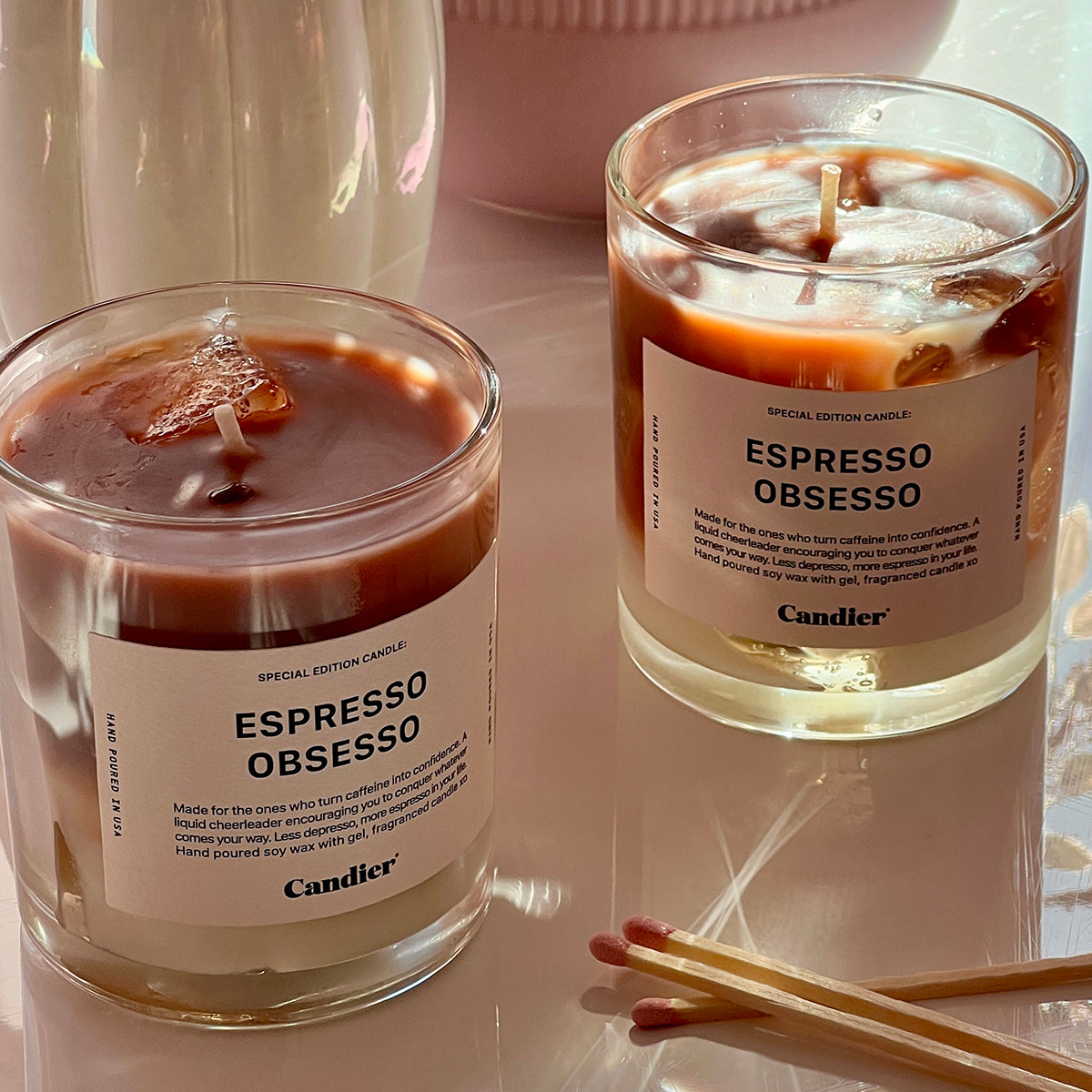 two Ice coffee espresso latte inspired candle with a label that reads Espresso Obsesso in romantic, dreamy, cozy setting