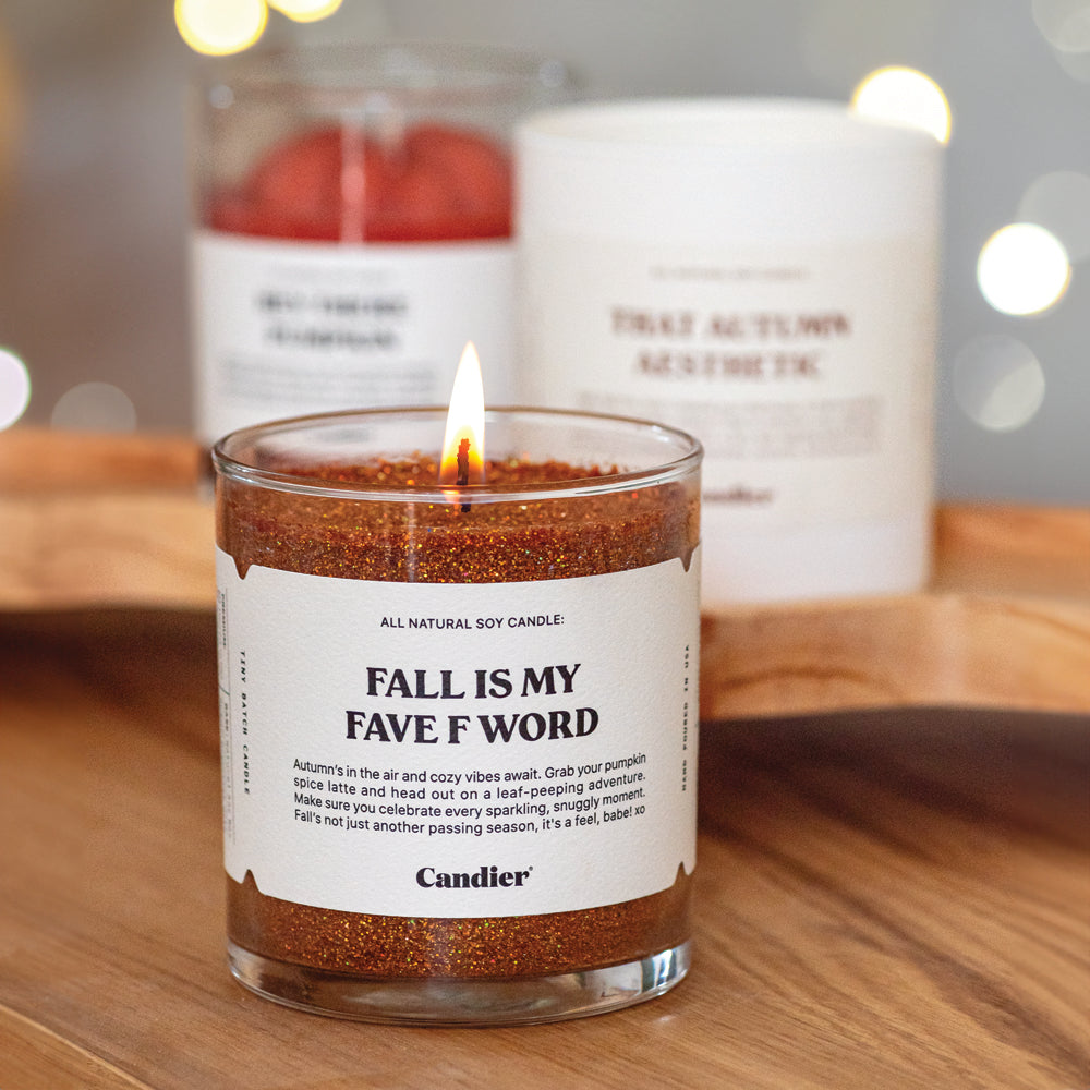 A sparkling glittery fall scented candle with a label that reads Fall Is My Fave F Word