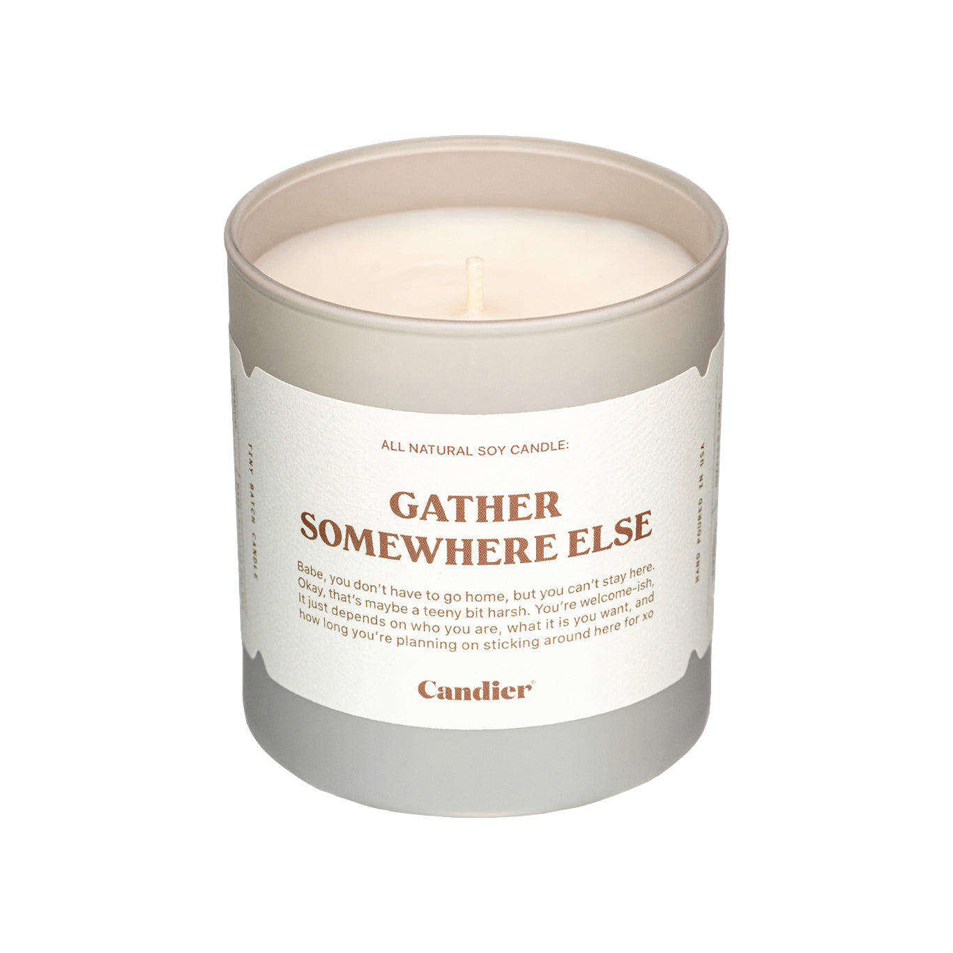 A luxe fall scented candle with a label that reads Gather Somewhere Else