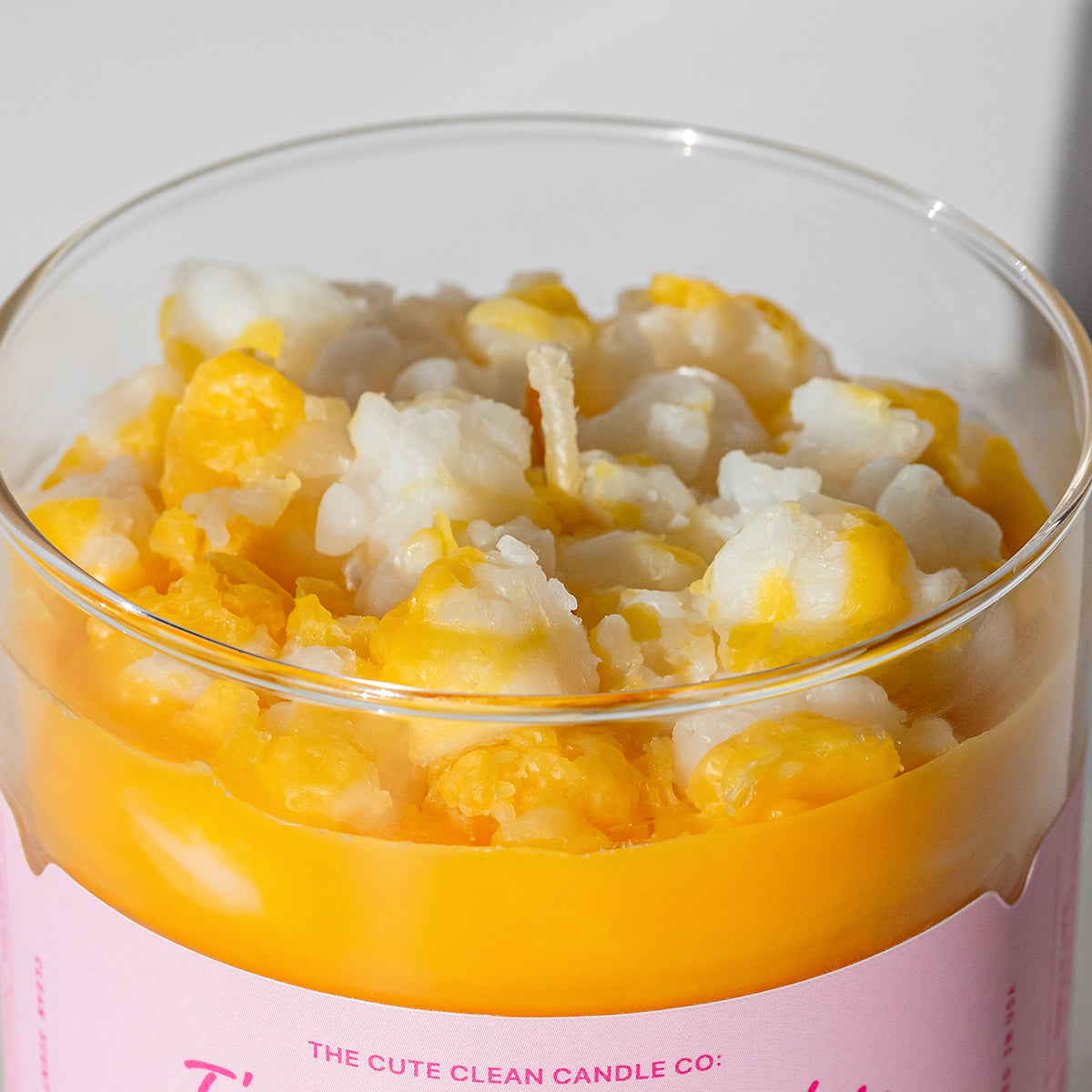 A fun premium Candier® scented candle topped with realistic wax popcorn