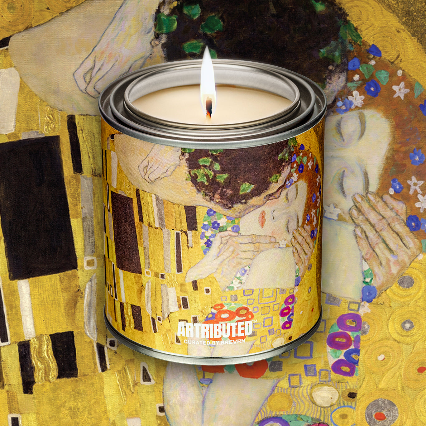 A premium candle wrapped in a high quality reproduction of Klimt's beloved The Kiss painting. The background is also filled with the artwork