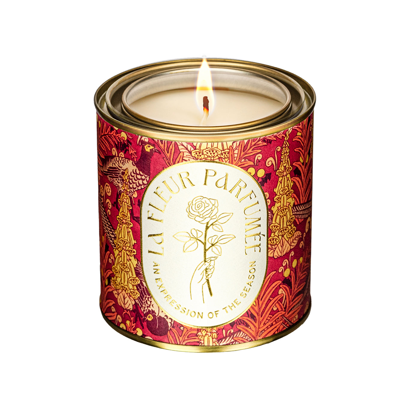 A luxury scented candle with a bold seasonal, fall, thanksgiving themed pattern, on a plain white background, with a crisp white label and gold writing that reads LA FLEUR PARFUMÉE: An Expression of the Season, and an illustration of a hand holding an elegant rose by the stem.