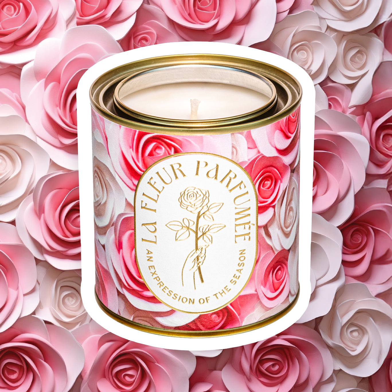 Luxury soy rose candle with elegant gold logo that reads La Fleur Parfumeé An Expression of the Season. The gold tone metal vessel is decorated with artwork of pink and cream roses, with the same rose pattern in the background