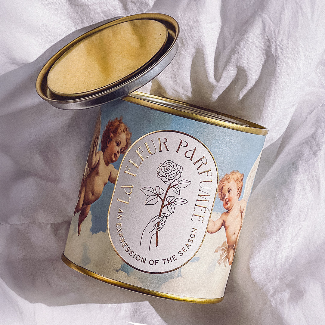 Hand-poured luxury scented candle in a pretty, aesthetic candle tin. A Parisian chic gift for women who love romantic candles.