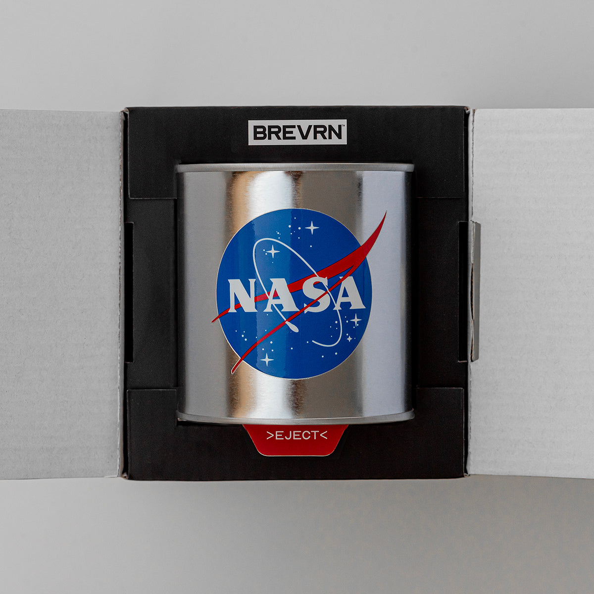 Close up of NASA 1969 Apollo scented candle, showing NASA logo AKA Meatball, and the ejection mechanism for the deluxe gift box