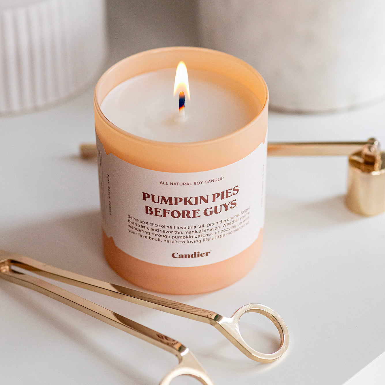 A cute luxury fall scented candle with a label that reads Pumpkin Pies Before Guys