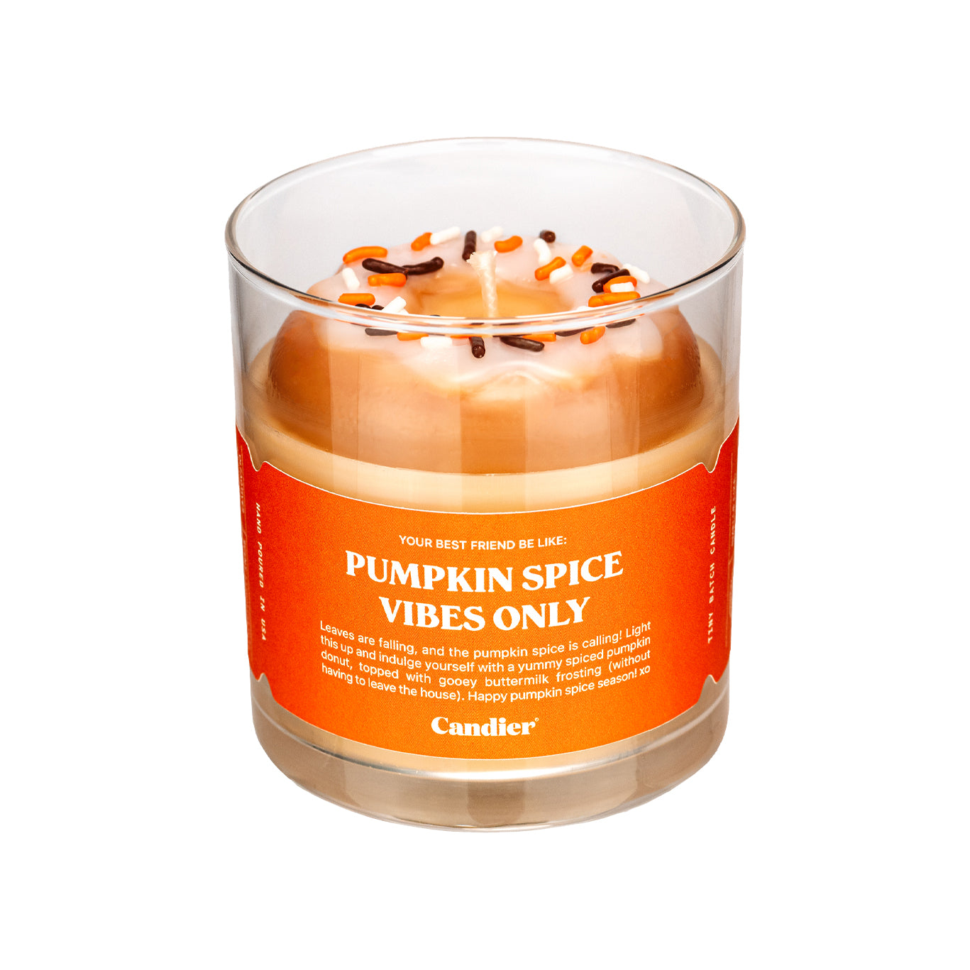 A cute fall scented candle with a wax glazed donut on top and a label that reads Pumpkin Spice Vibes Only