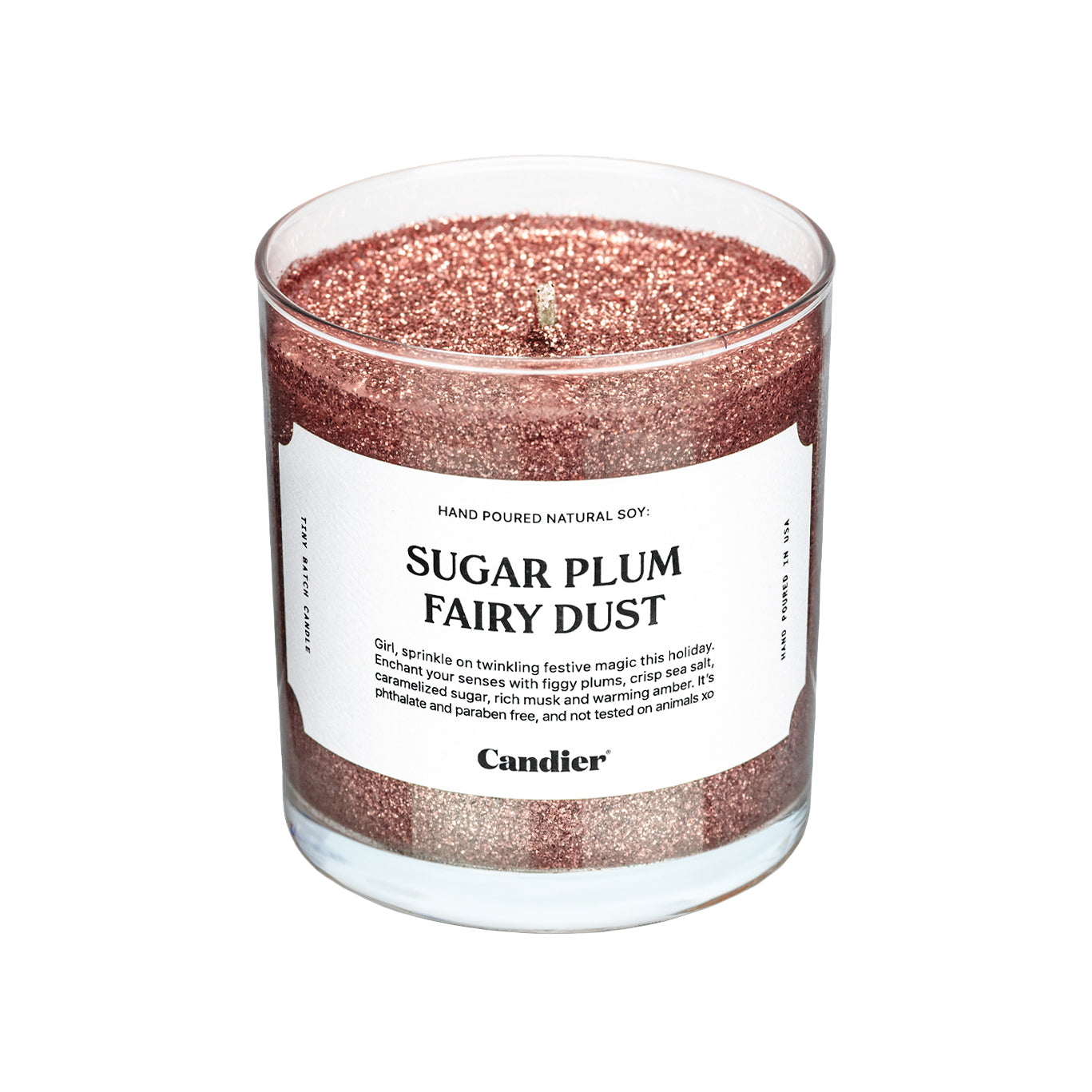 A glittery pink Christmas themed scented candle with a label that reads Sugar Plum Fairy Dust by Candier