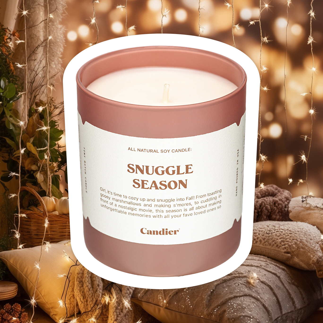 a luxury scented candle in mocha brown glass and a message that reads Snuggle Season, with a background of fashionable fall decor