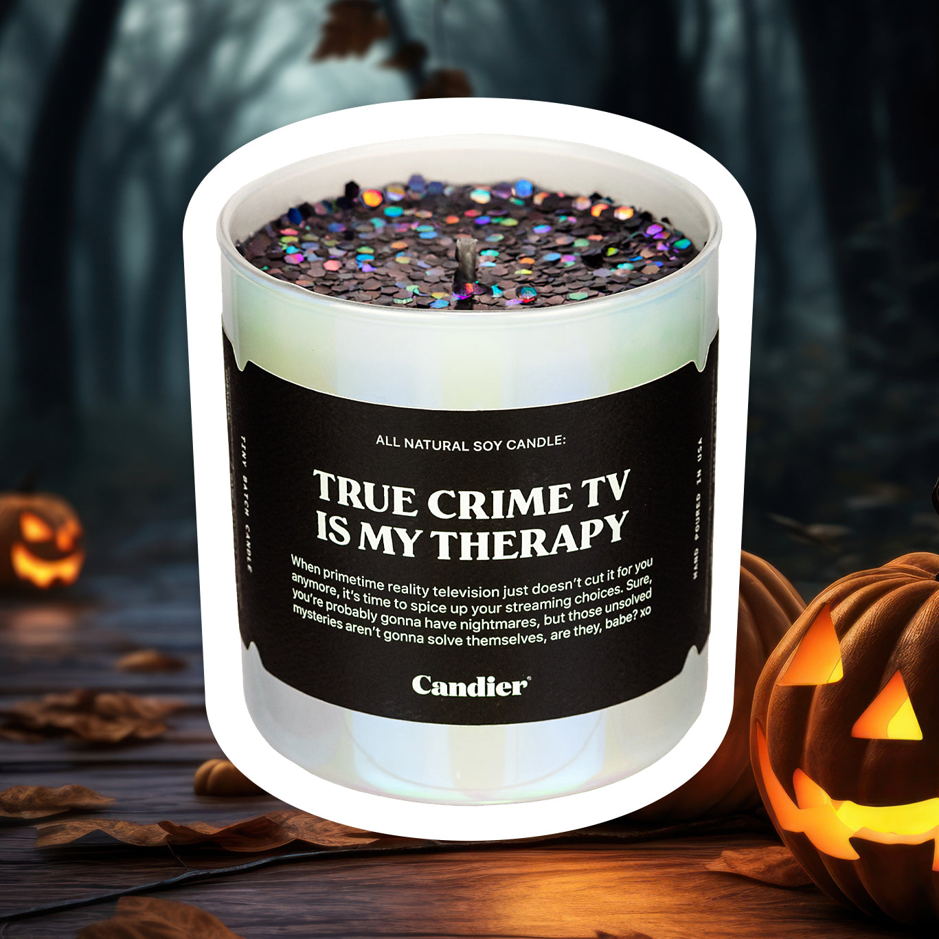 a shiny luxury scented candle, with sparkling plant based candle glitter, and a black label that reads True Crime TV Is My Therapy, with a spooky halloween background 