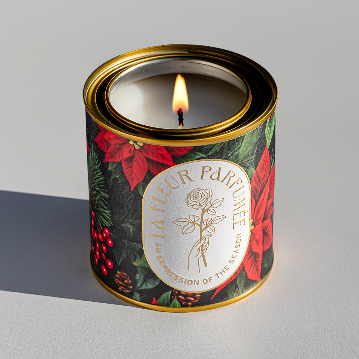 A special Christmas candle with bold red art of poinsettias